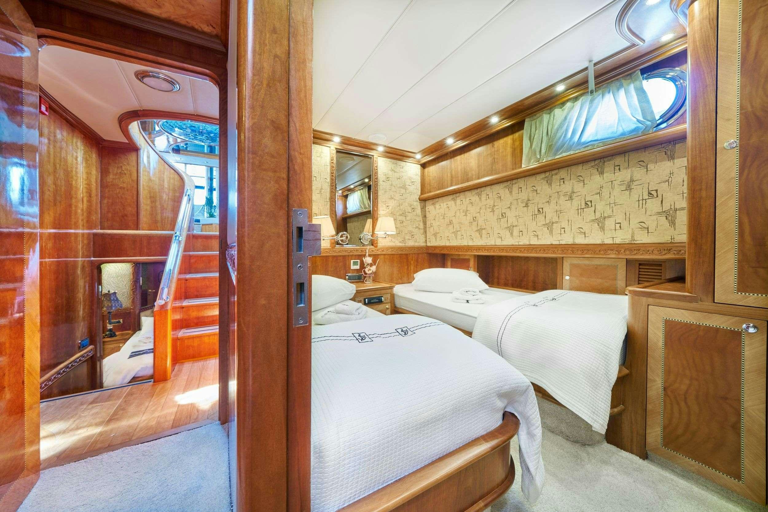 a room with two beds aboard LOTUS Yacht for Charter