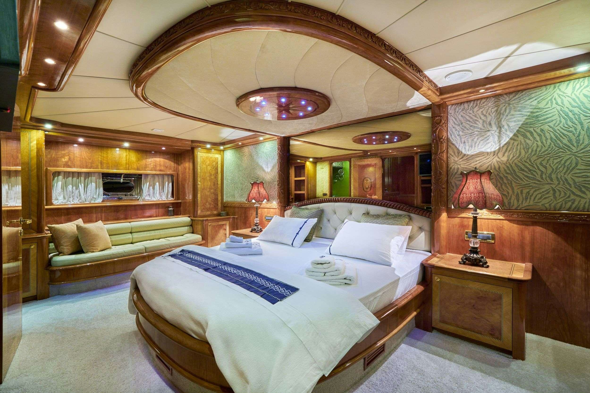 a large bedroom with a large mirror aboard LOTUS Yacht for Charter