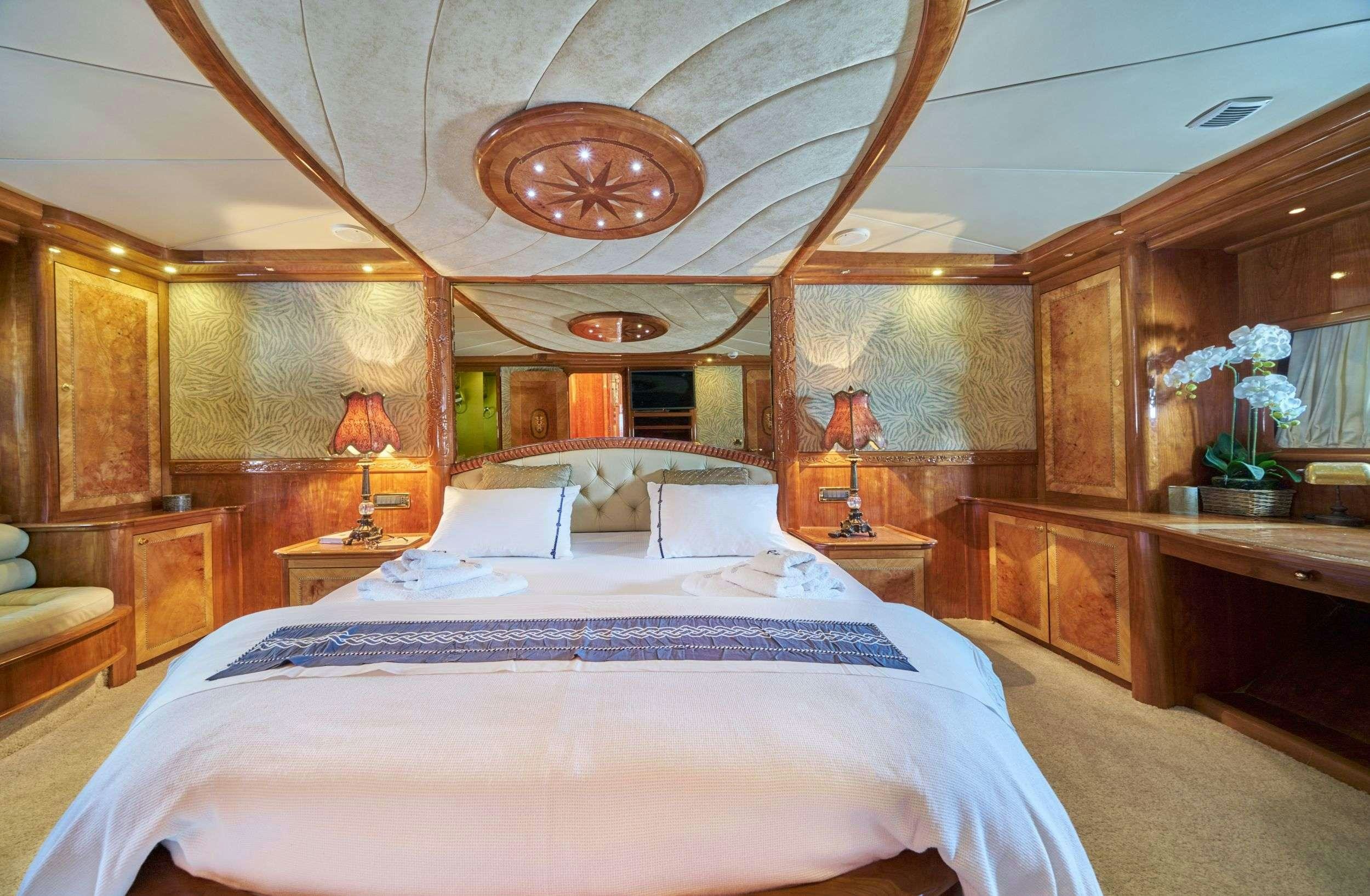 a large bedroom with a large bed aboard LOTUS Yacht for Charter