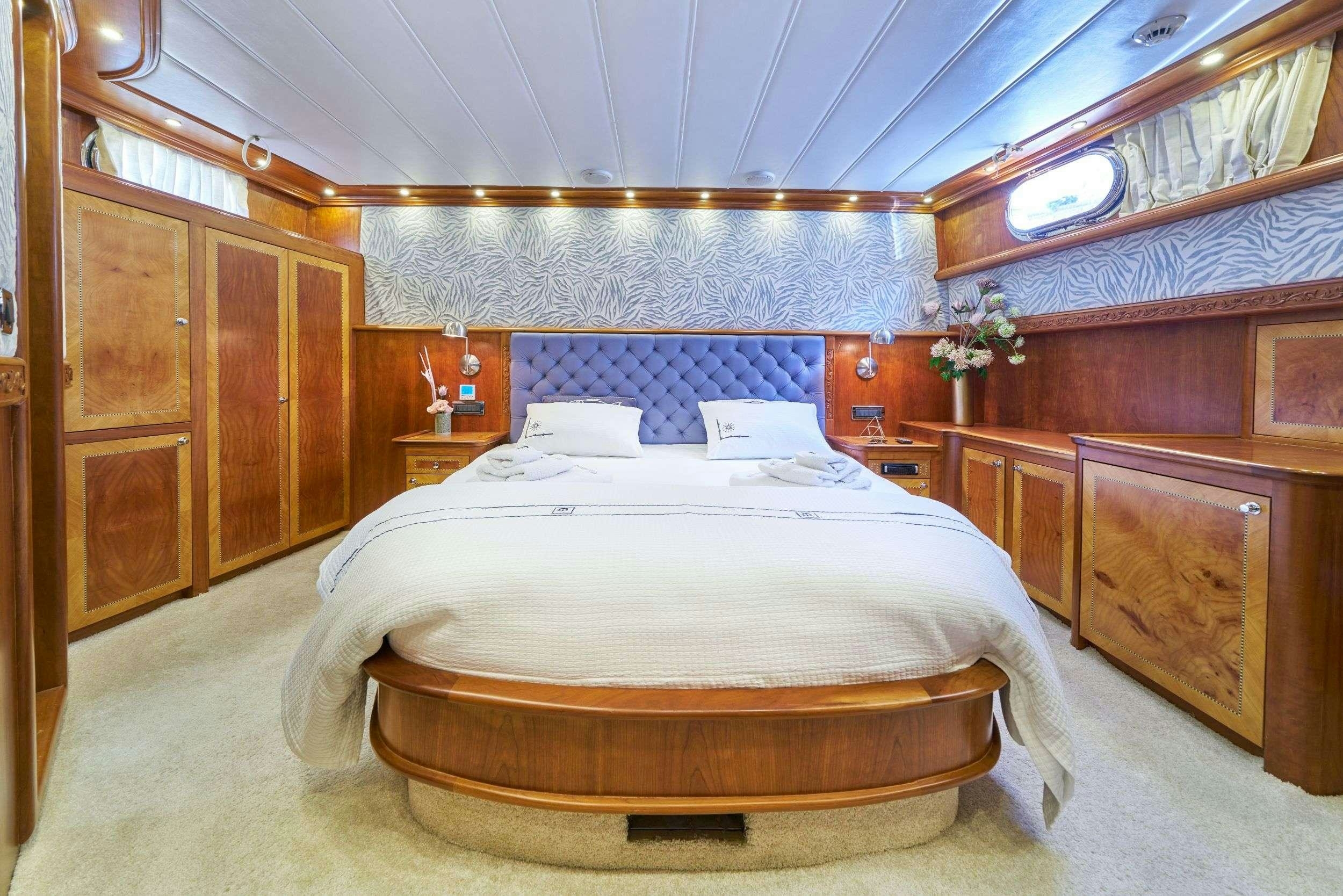 a bed in a room aboard LOTUS Yacht for Charter