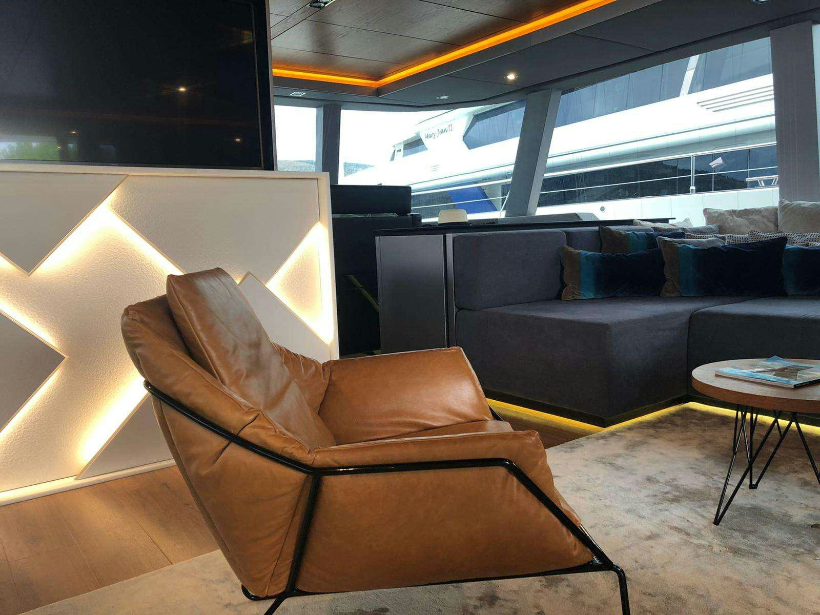 a couch and a table in a room aboard 7X Yacht for Charter