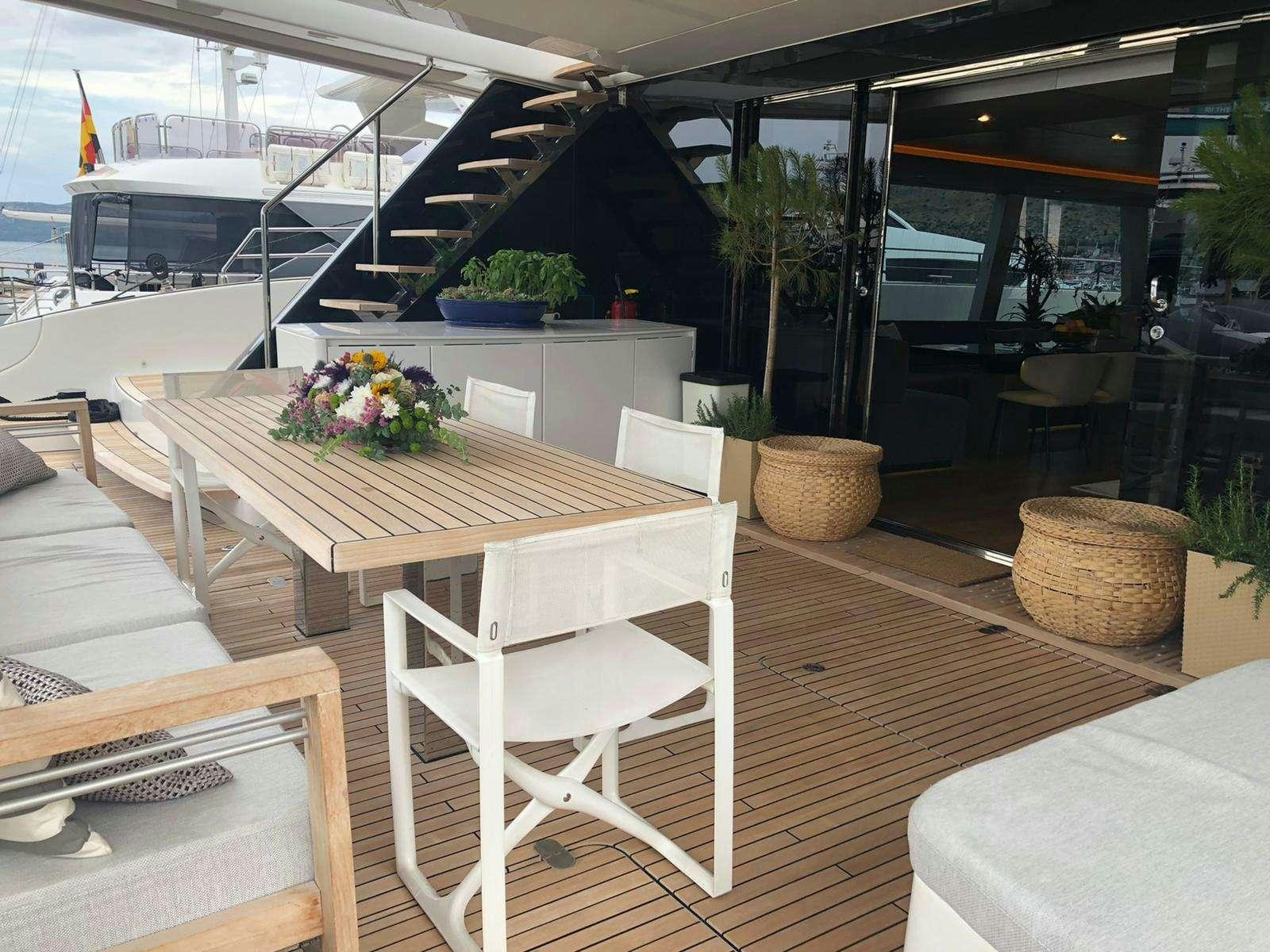 a room with tables and chairs aboard 7X Yacht for Charter