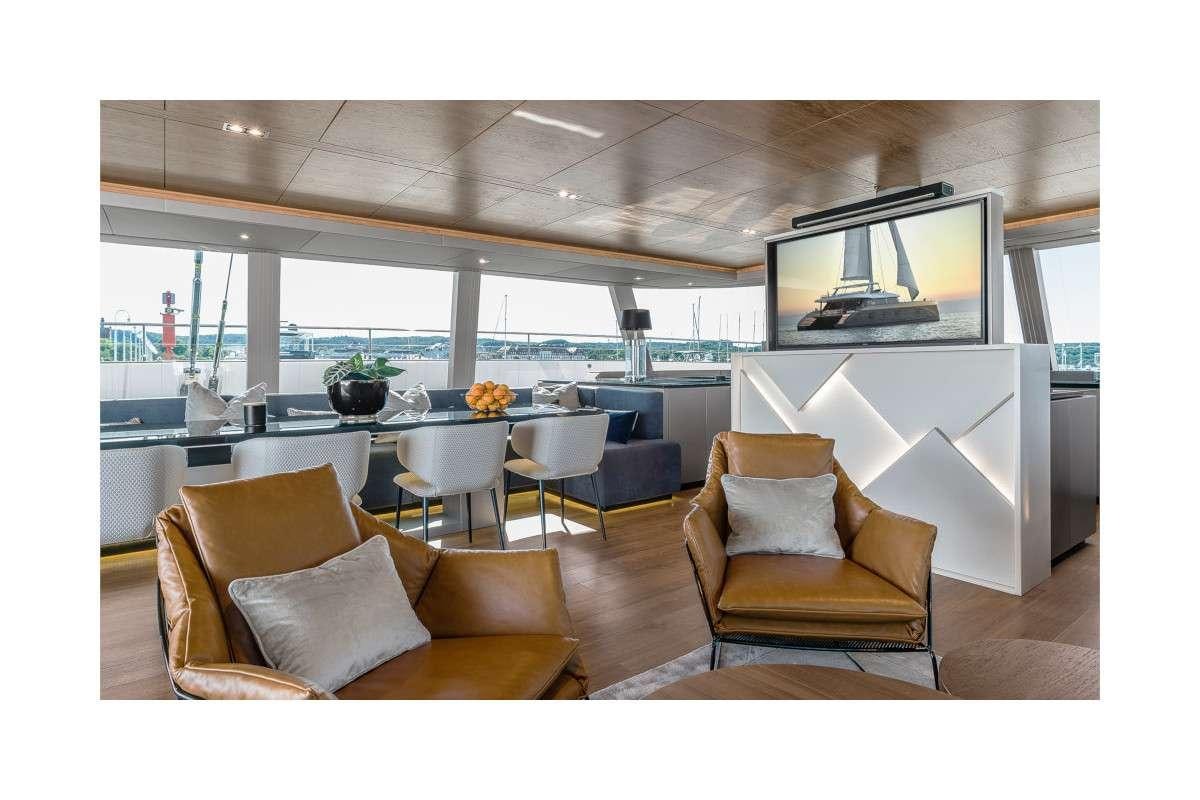 a living room with a large television aboard 7X Yacht for Charter