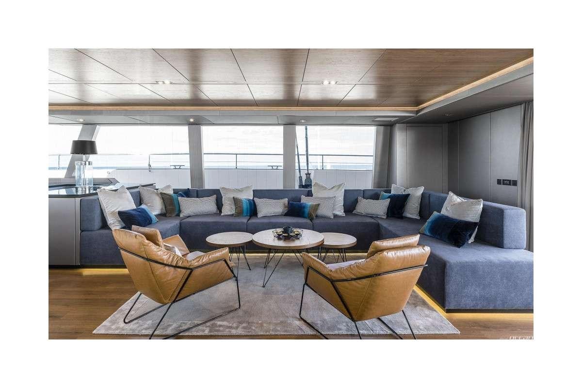 a living room with a couch and a table aboard 7X Yacht for Charter