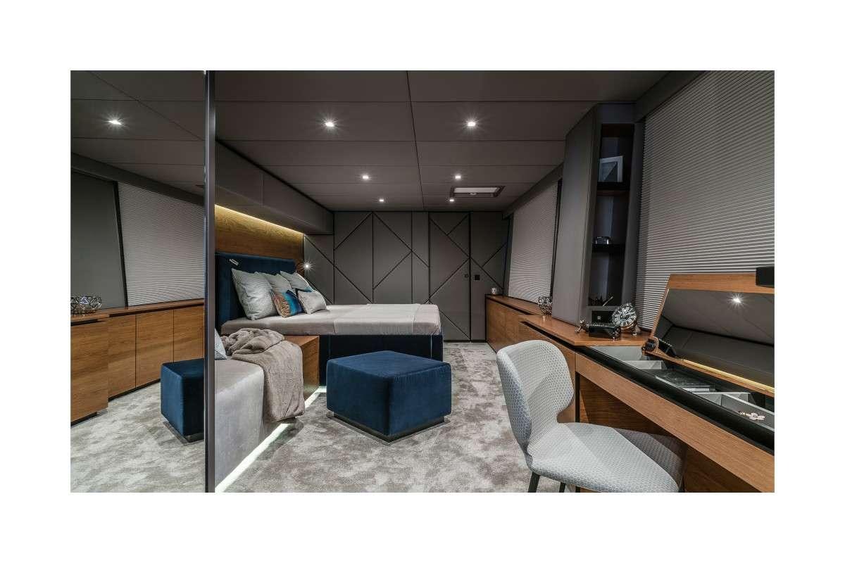 a room with a bed and a desk aboard 7X Yacht for Charter