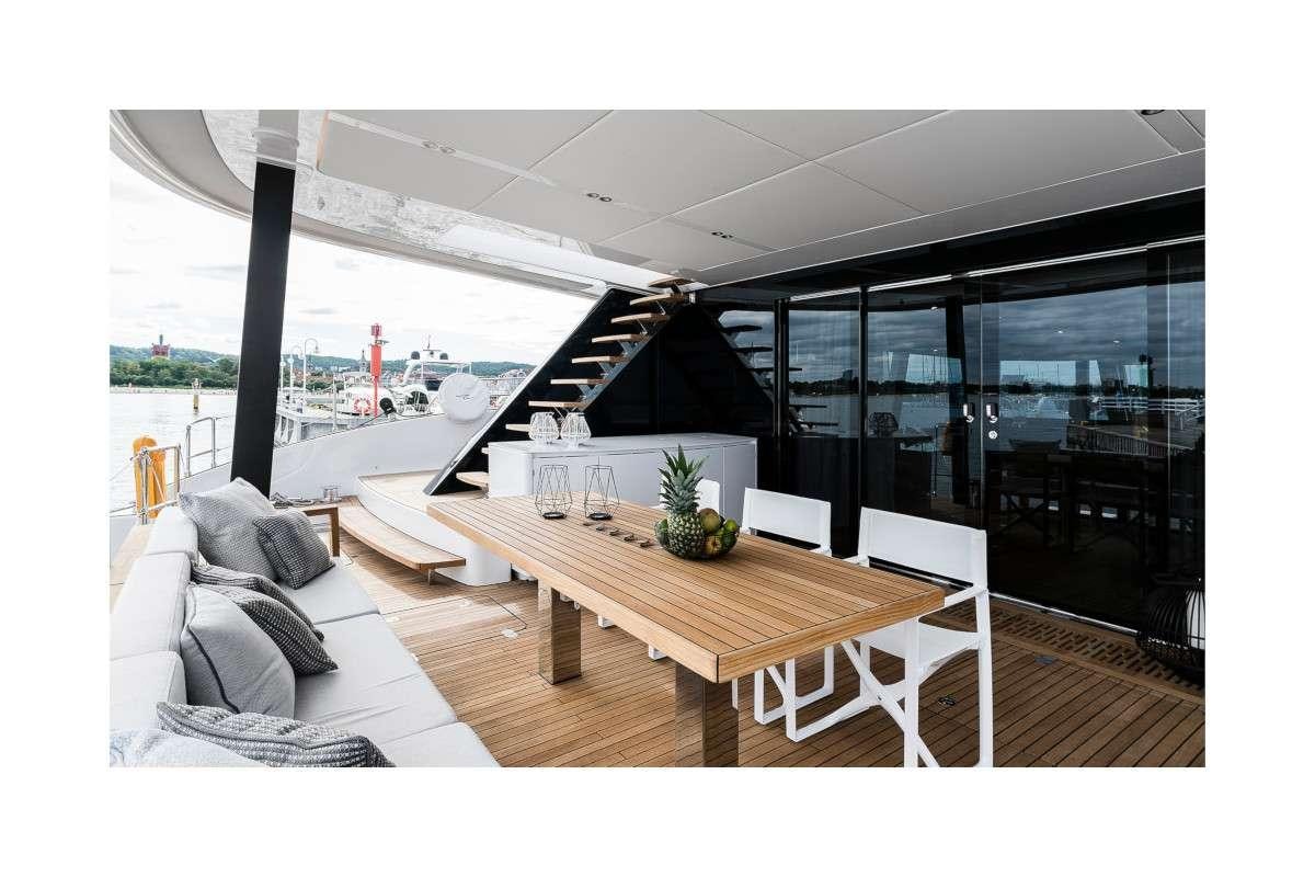 a room with a table and couches aboard 7X Yacht for Charter