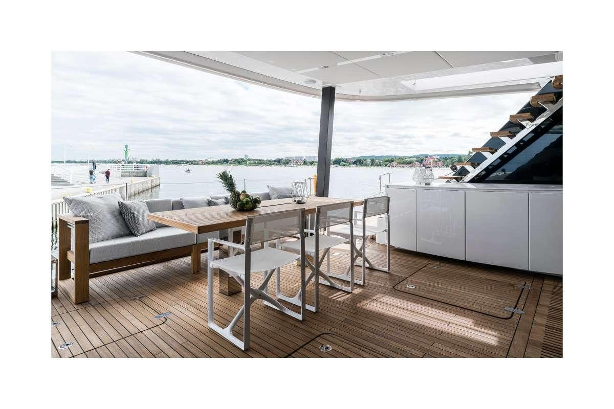 a room with a table and chairs aboard 7X Yacht for Charter