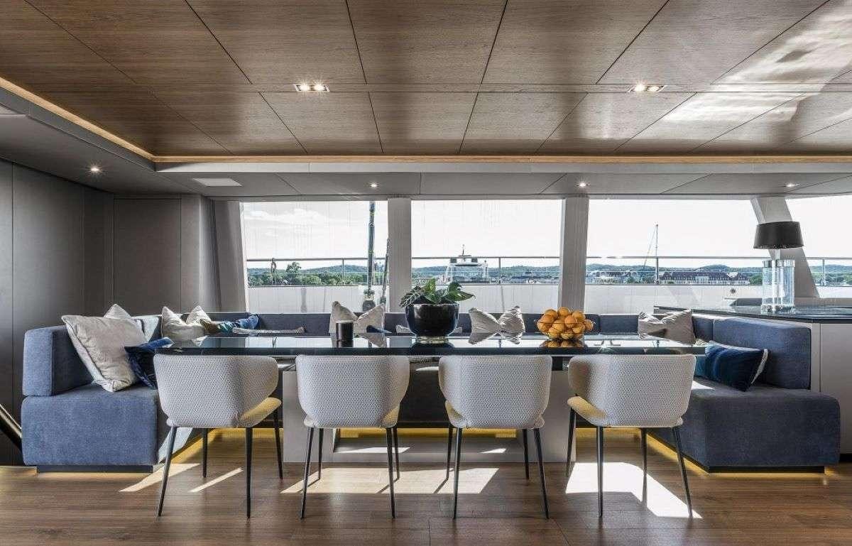 a large room with a table and chairs aboard 7X Yacht for Charter