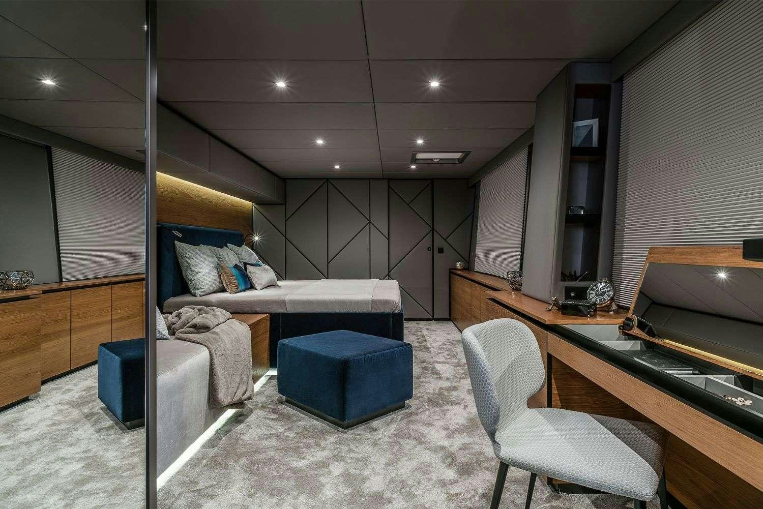 a room with a bed and desk aboard 7X Yacht for Charter