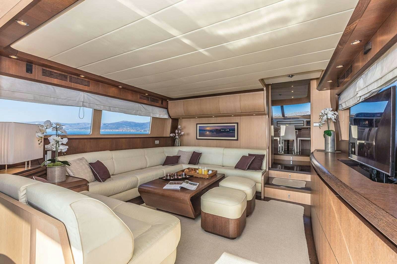 a living room with a large screen aboard HOPE I Yacht for Charter