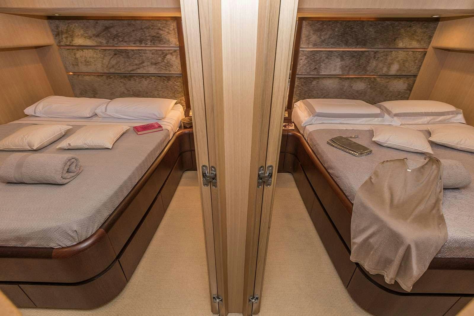 a room with beds and a closet aboard HOPE I Yacht for Charter