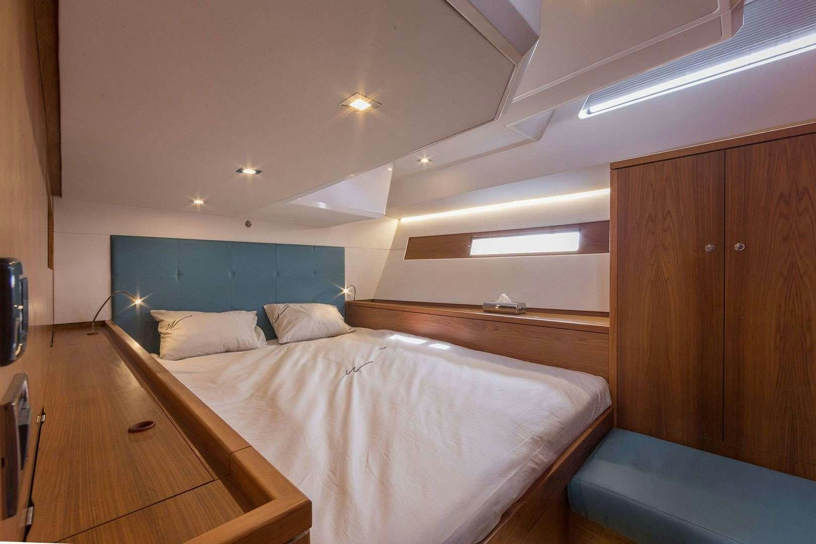 a room with two beds aboard ADIQELL (Pilot Saloon 55) Yacht for Charter
