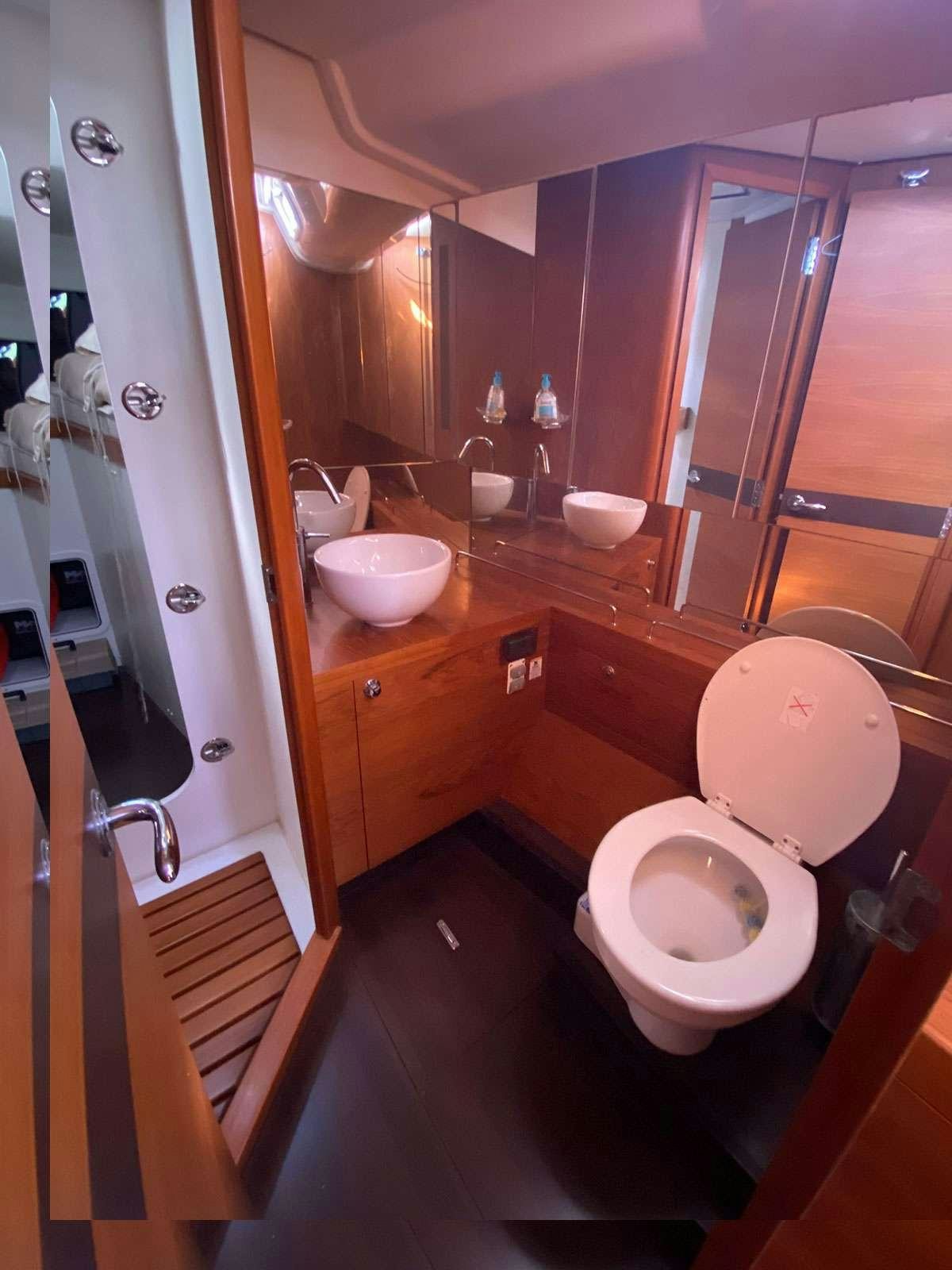 a bathroom with a toilet and sink aboard ADIQELL (Pilot Saloon 55) Yacht for Charter