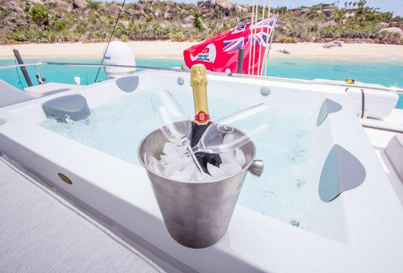 a bucket with a straw on it by a boat aboard ORION Yacht for Charter