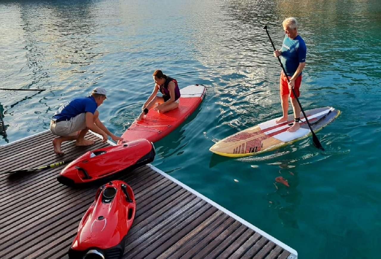 a group of people rowing a canoe aboard ORION Yacht for Charter