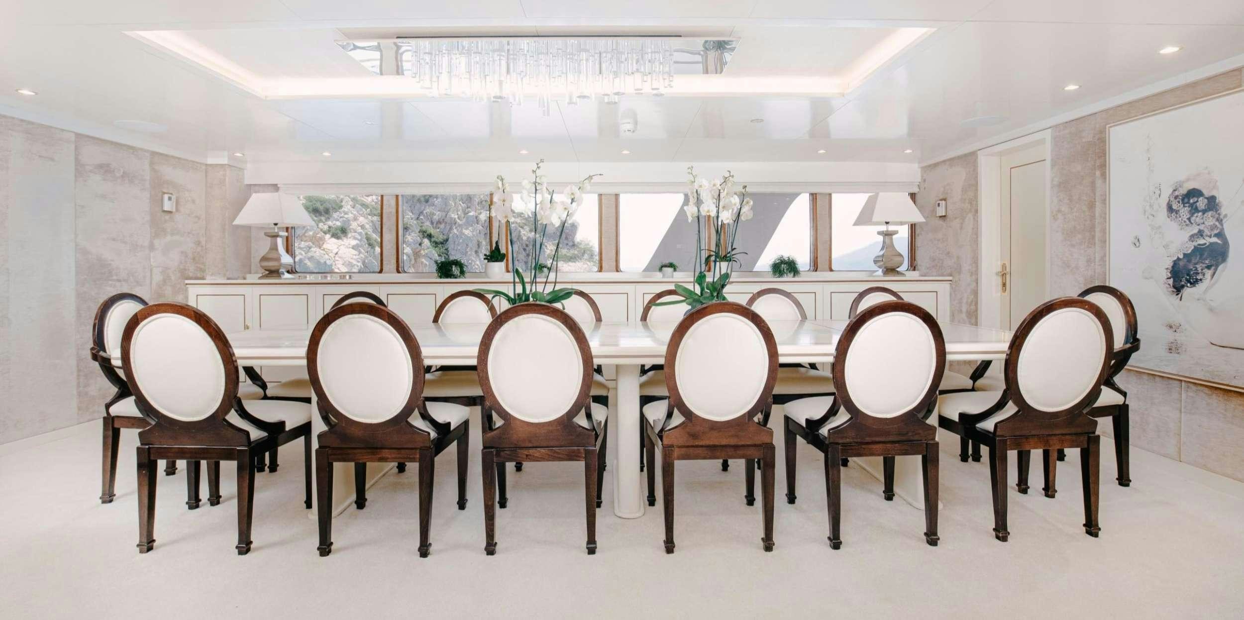 a room with a table and chairs aboard ITOTO Yacht for Charter