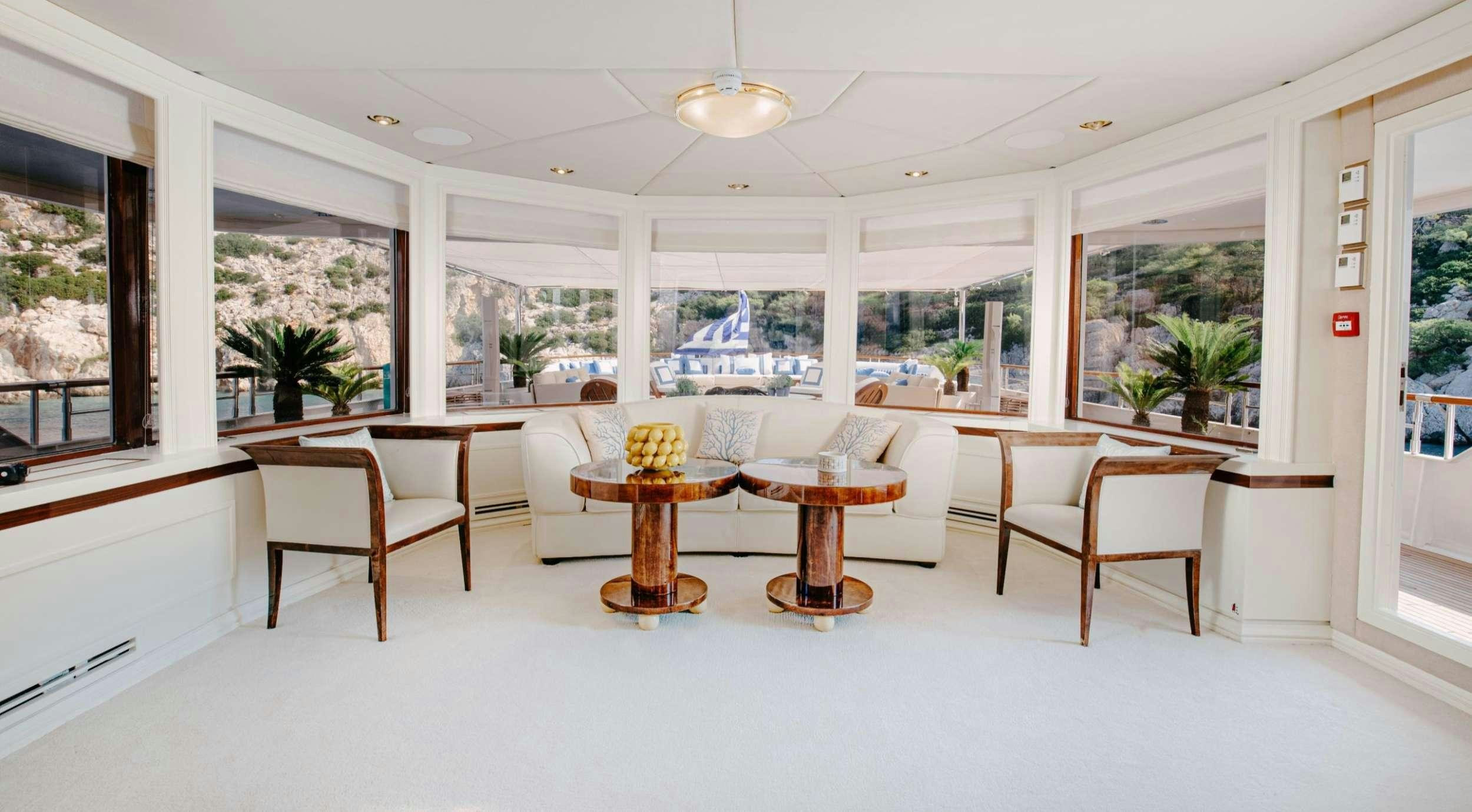 a room with a table and chairs aboard ITOTO Yacht for Charter