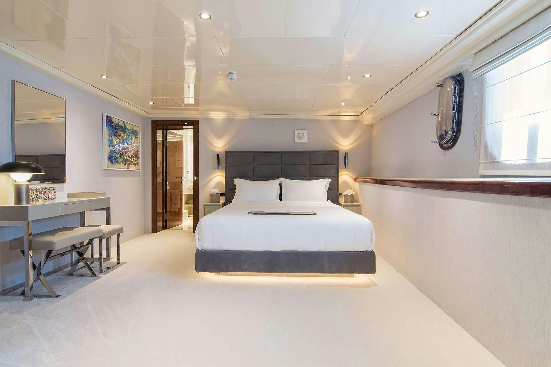 a room with a bed and a desk aboard MOKA Yacht for Charter