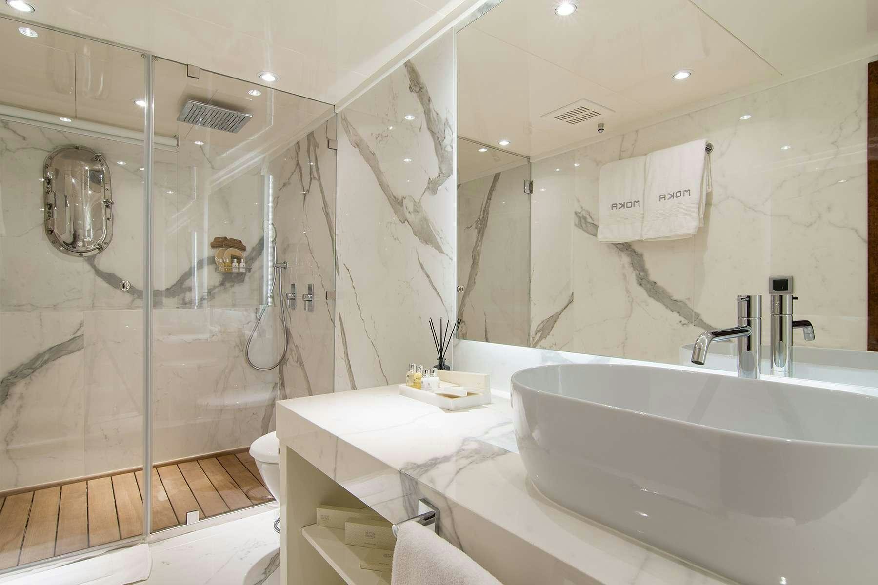 a bathroom with a large mirror aboard MOKA Yacht for Charter
