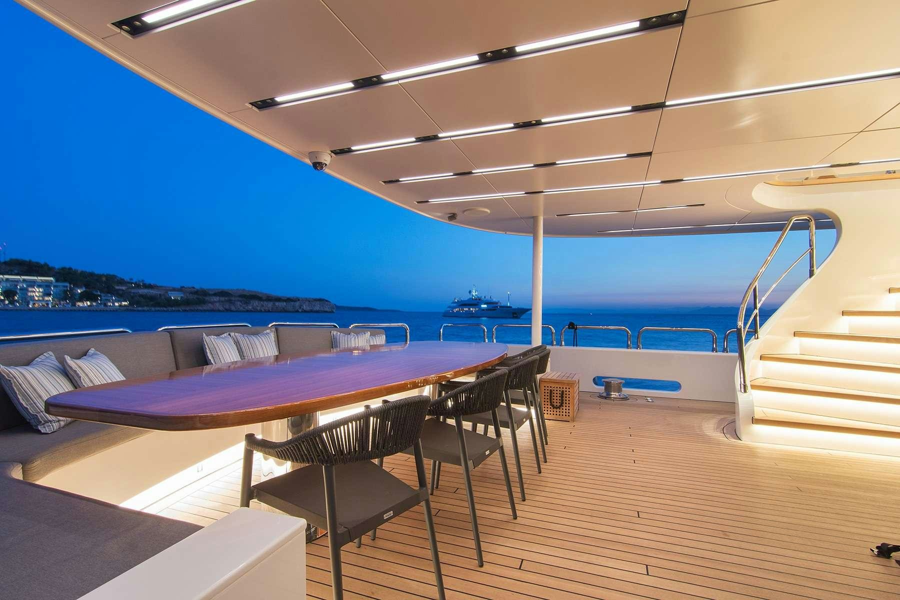 a pool with a deck and a deck overlooking the water aboard MOKA Yacht for Charter