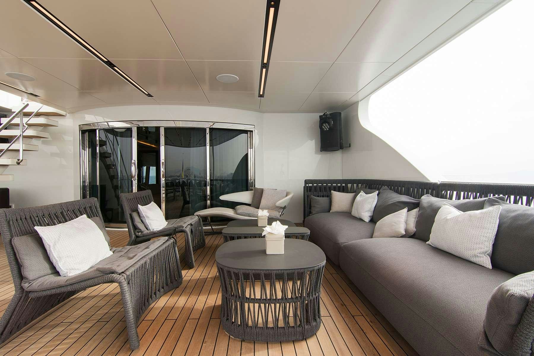 a living room with a large window aboard MOKA Yacht for Charter