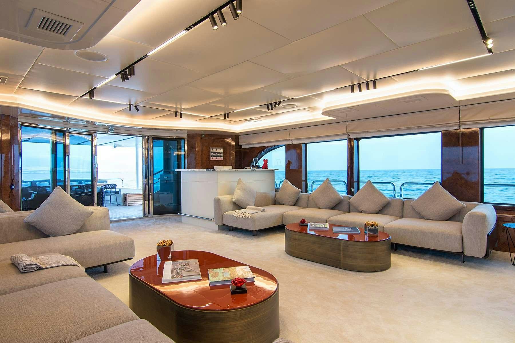 a living room with a large window aboard MOKA Yacht for Charter