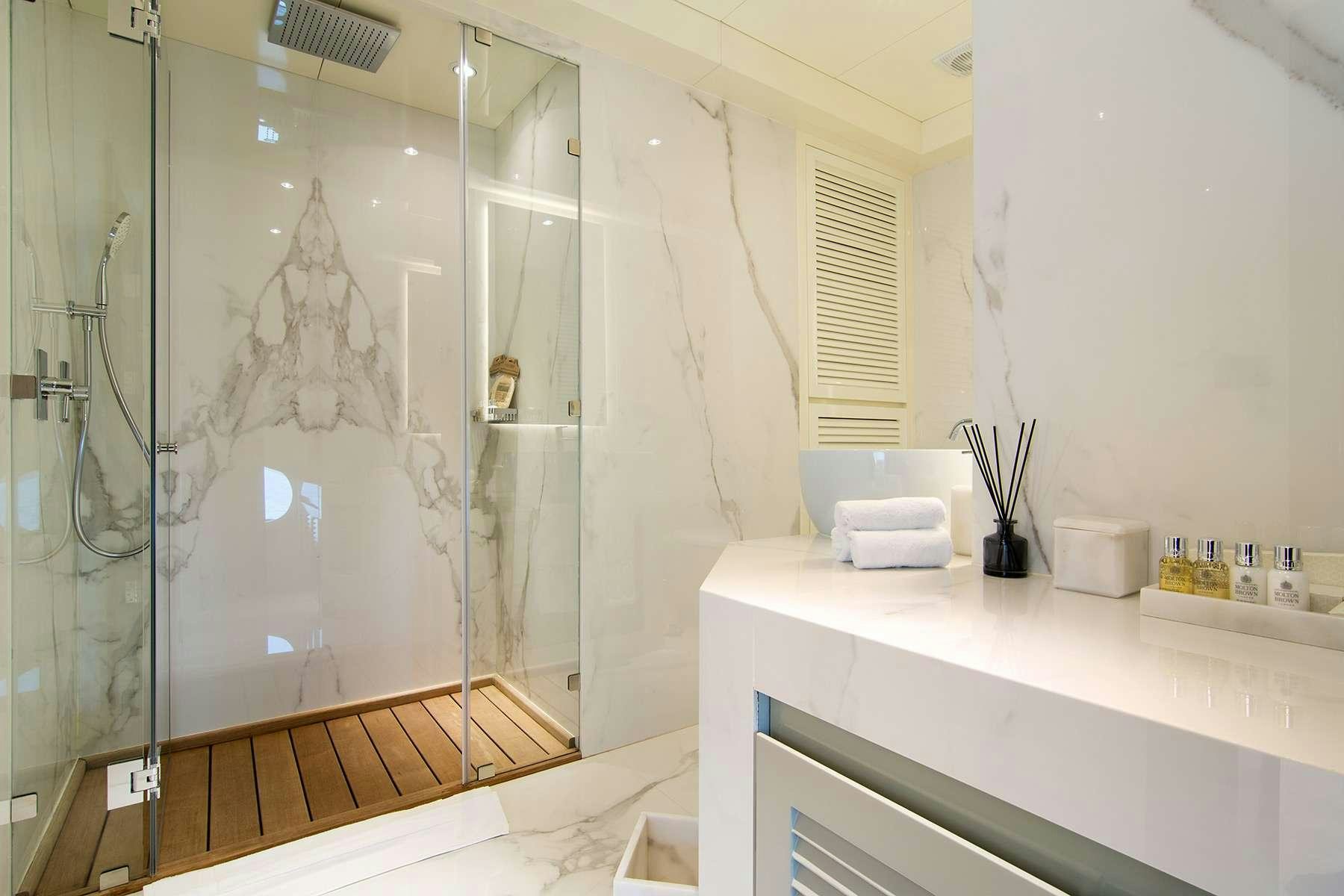 a bathroom with a glass shower aboard MOKA Yacht for Charter