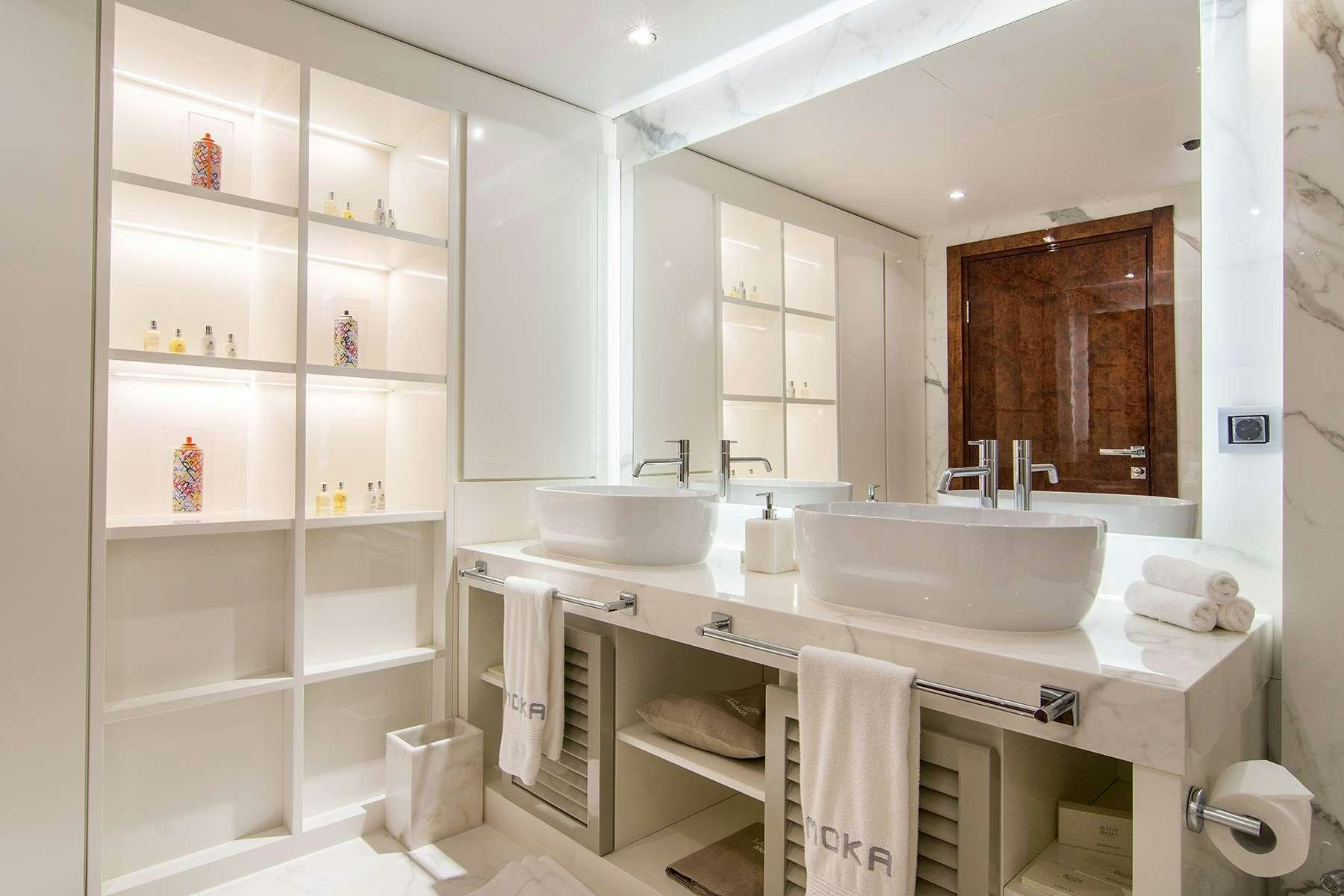 a bathroom with a sink and a mirror aboard MOKA Yacht for Charter
