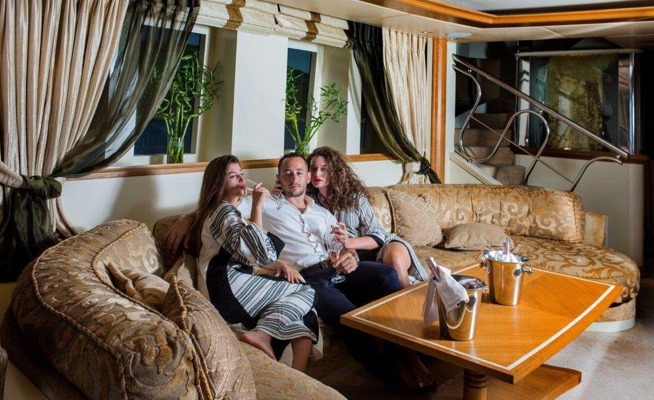 a group of people sitting on a couch aboard CARMEN FONTANA Yacht for Charter