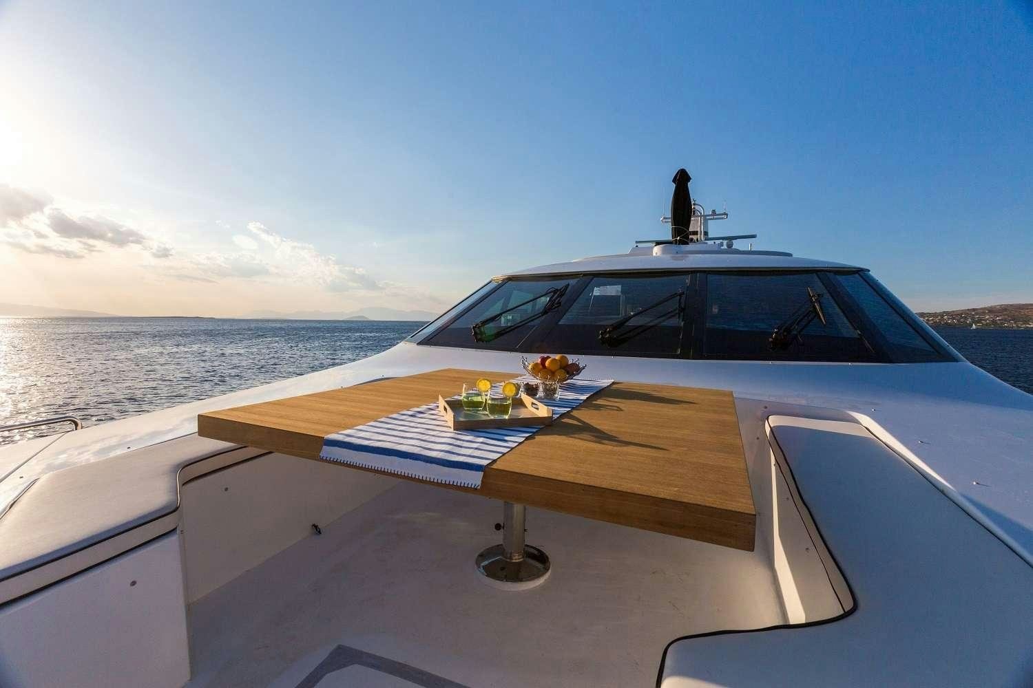 a boat with a table and chairs on the deck aboard AQUARELLA Yacht for Charter