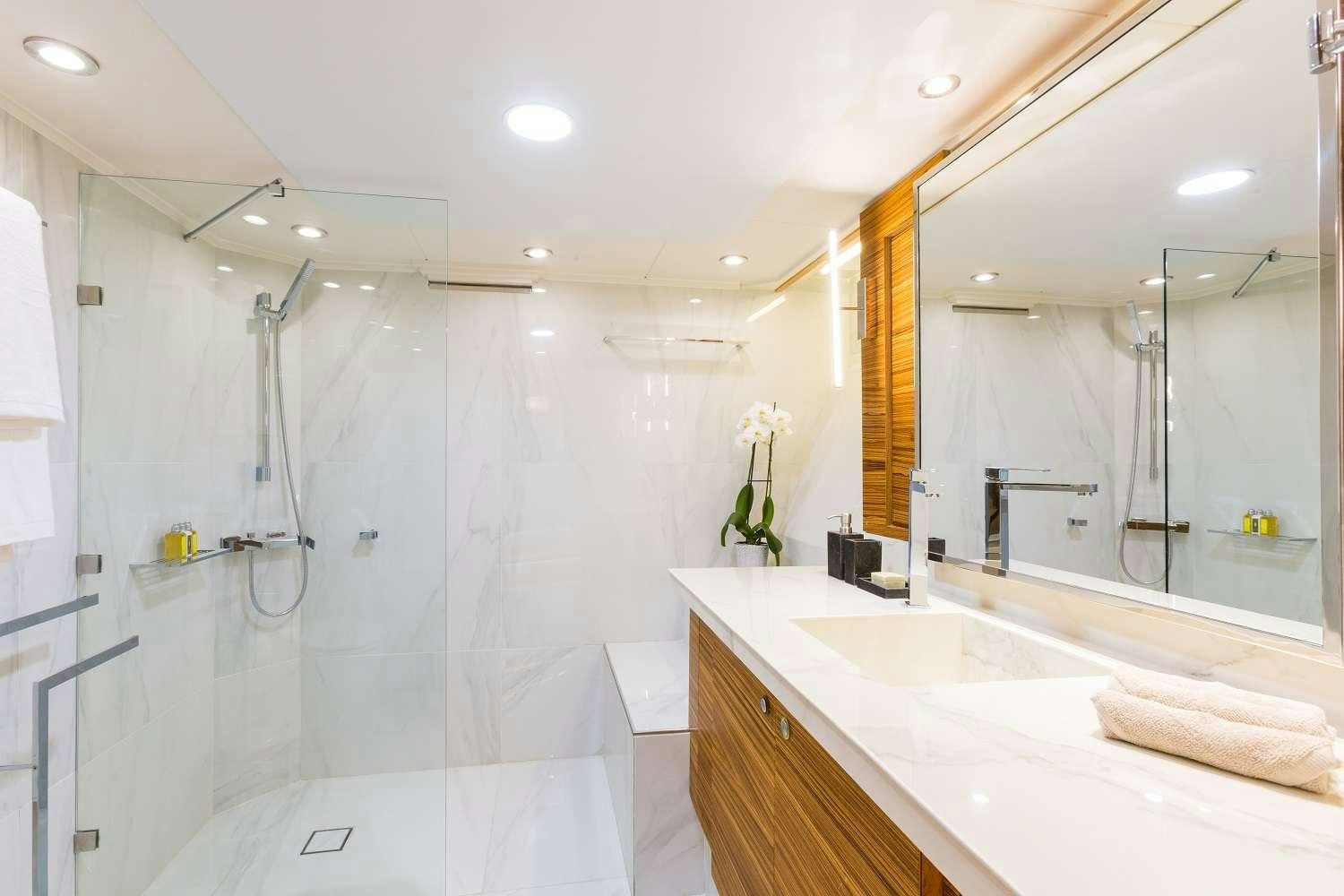 a bathroom with a shower and sink aboard AQUARELLA Yacht for Charter
