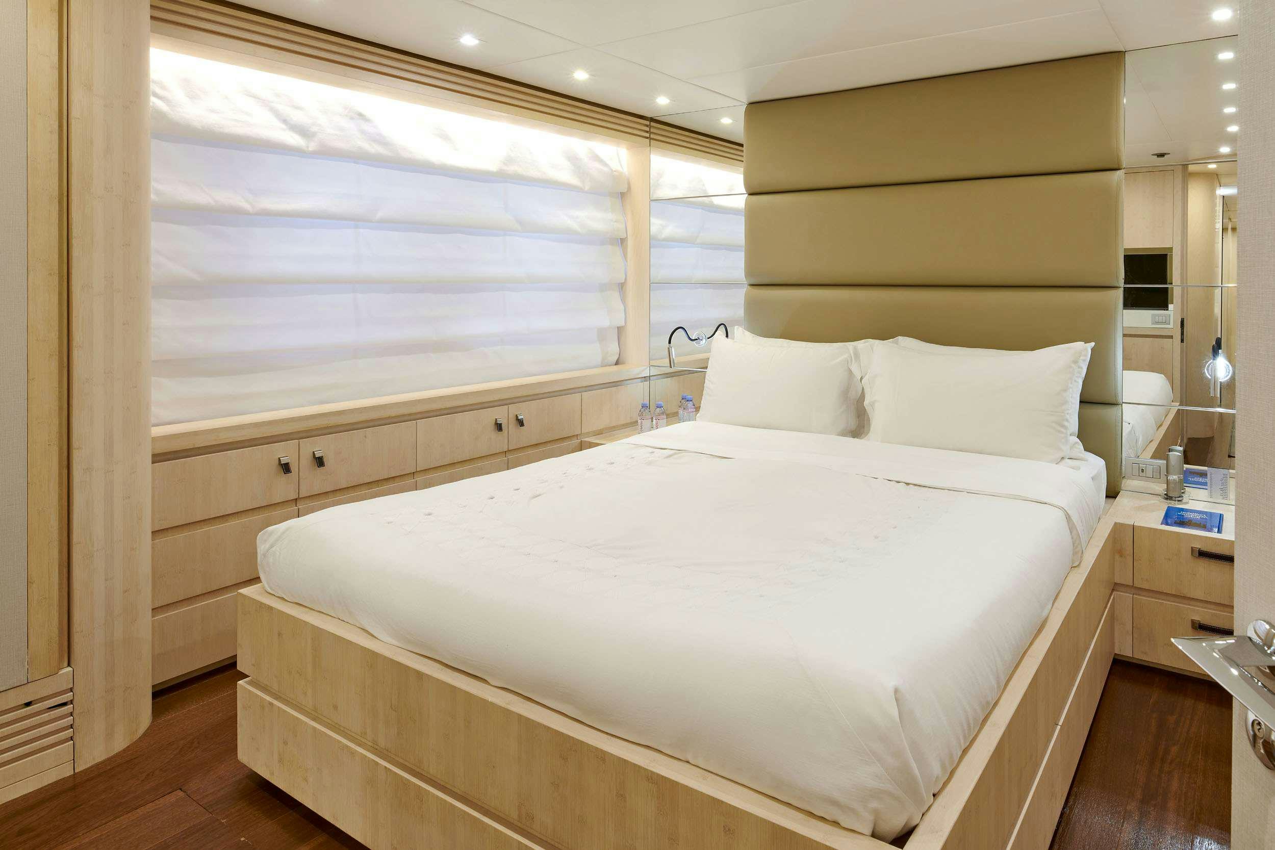 a bed with white sheets aboard WHITE KNIGHT Yacht for Charter