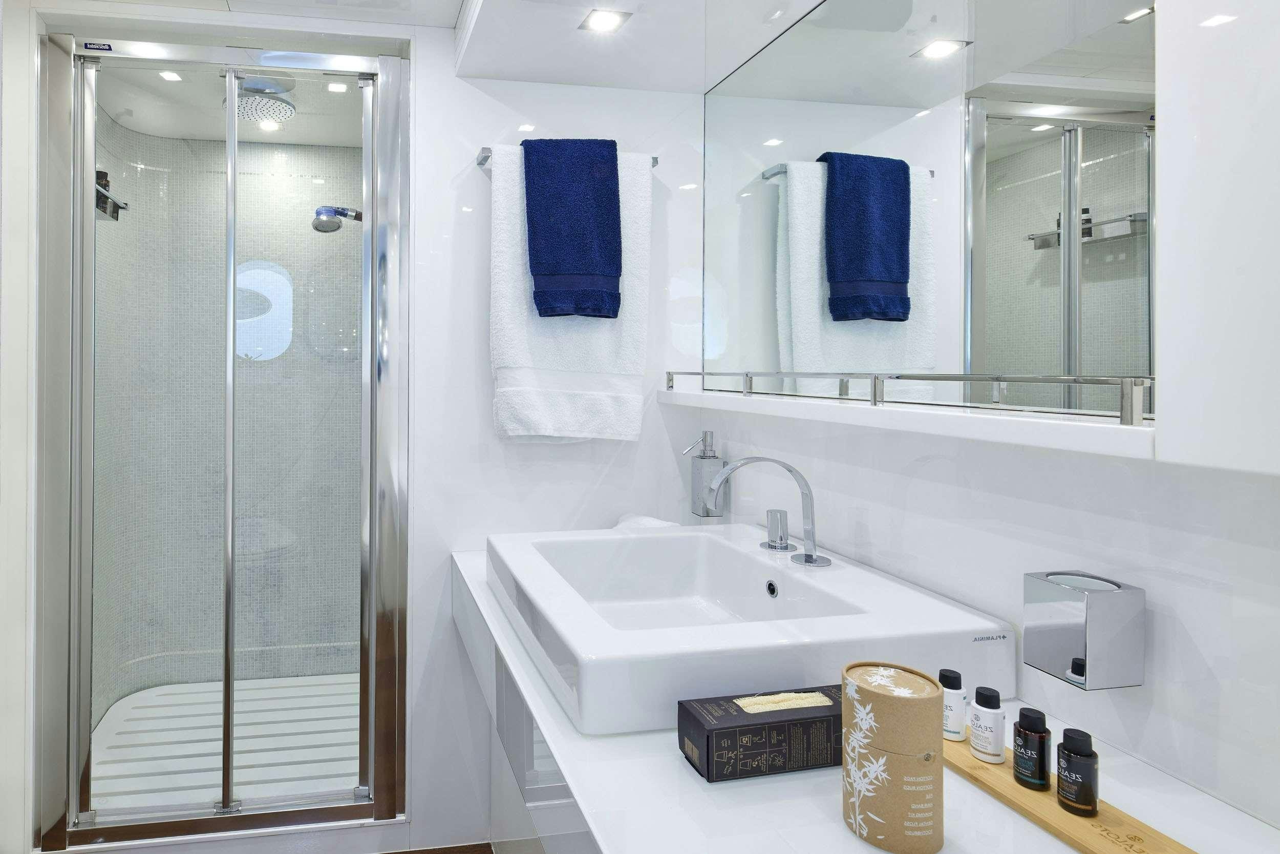 a bathroom with a sink and a mirror aboard WHITE KNIGHT Yacht for Charter