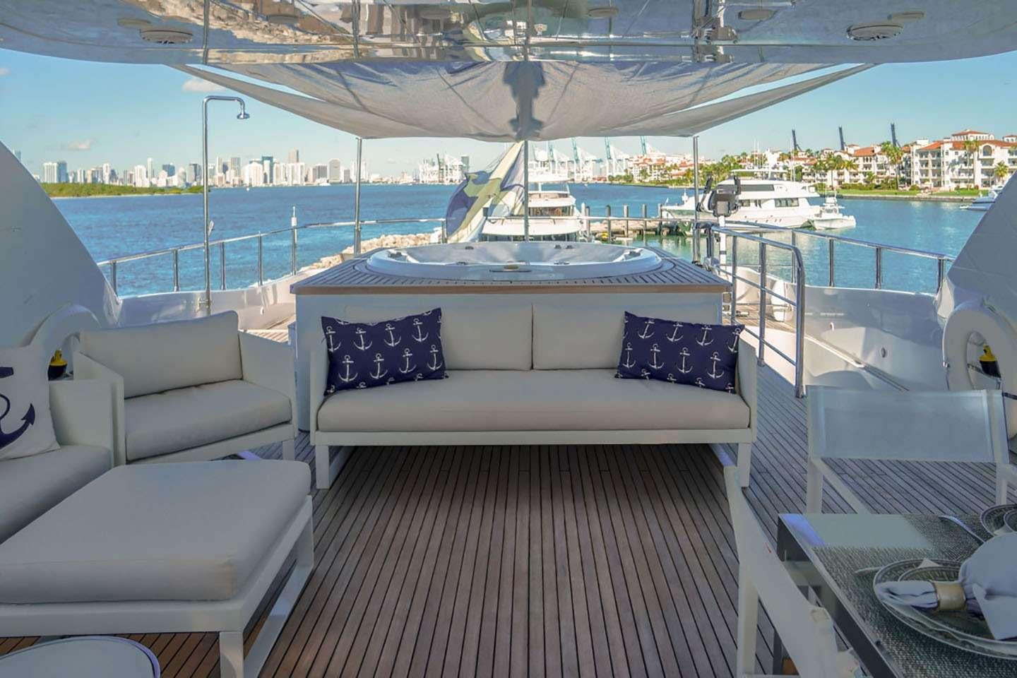 a white couch on a deck overlooking a body of water aboard WHITE KNIGHT Yacht for Charter