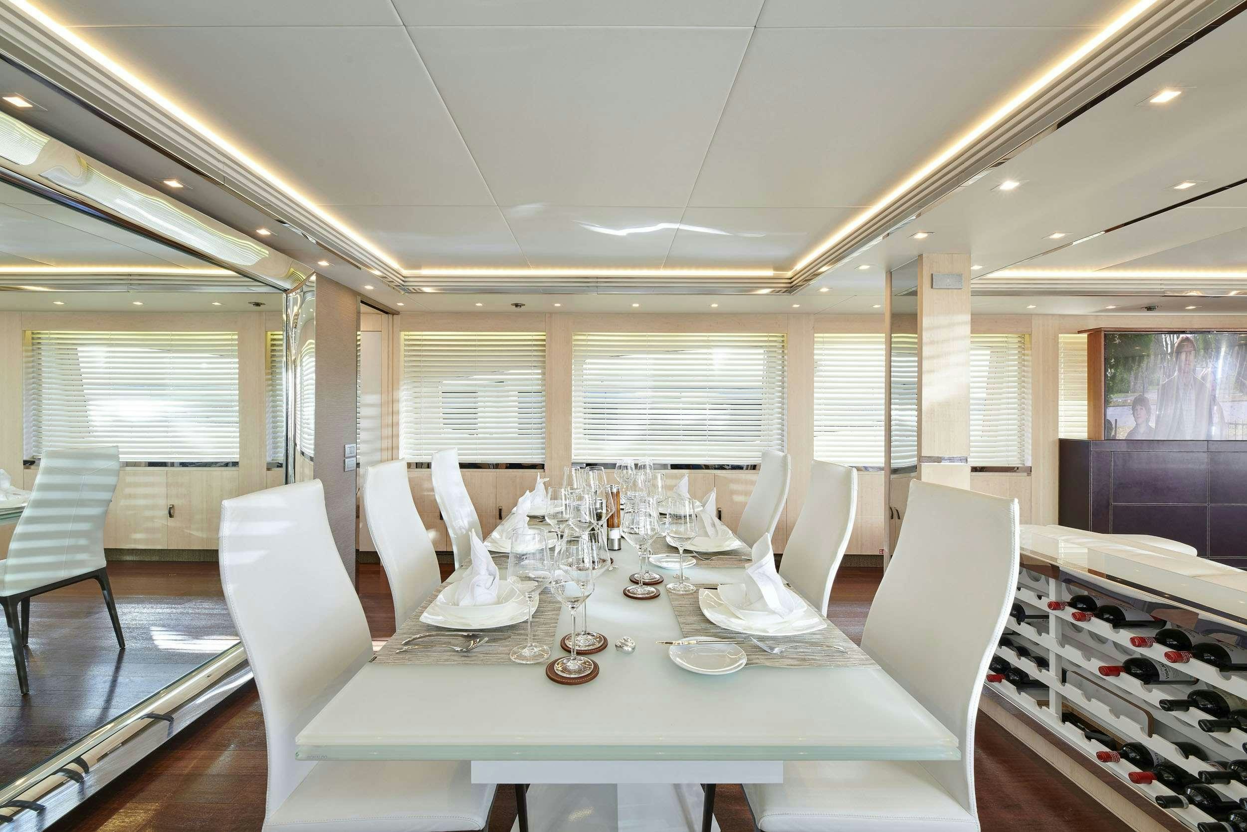 a room with a table chairs and a window aboard WHITE KNIGHT Yacht for Charter