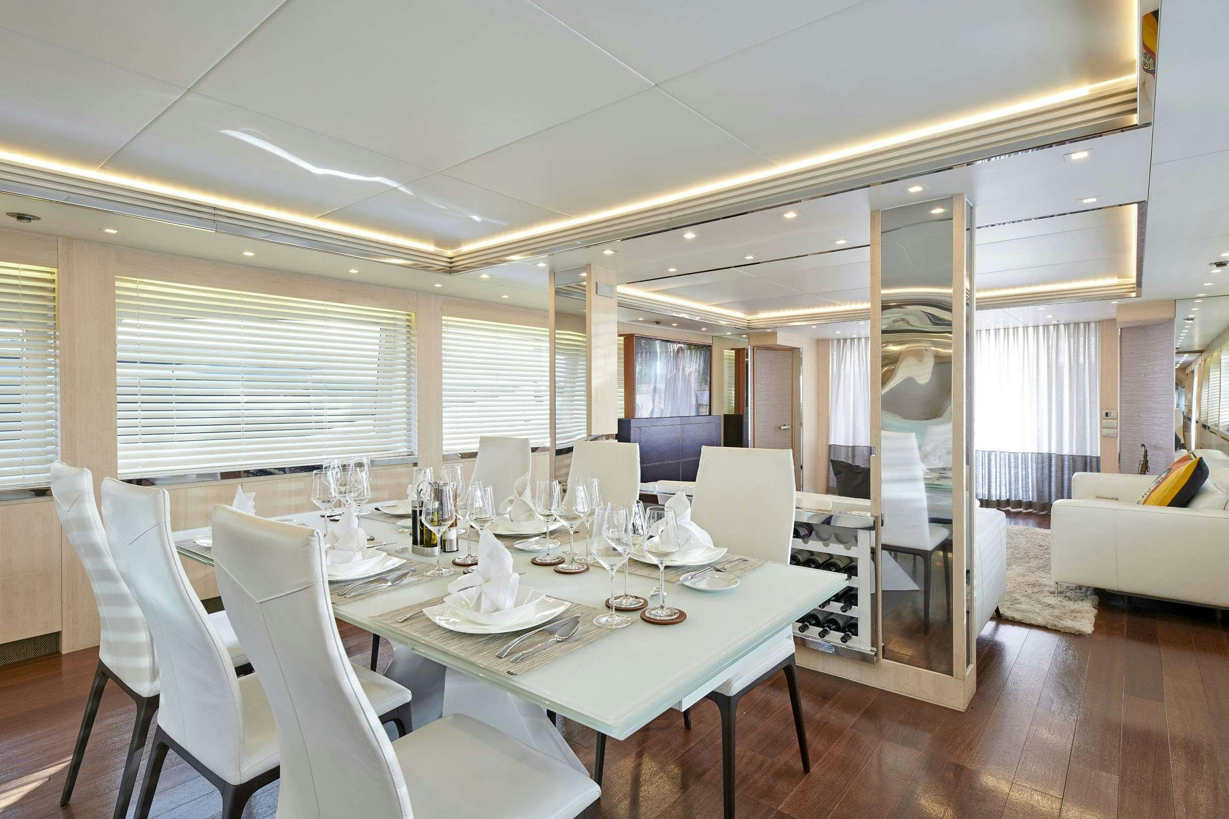 a dining room with white chairs and a table aboard WHITE KNIGHT Yacht for Charter