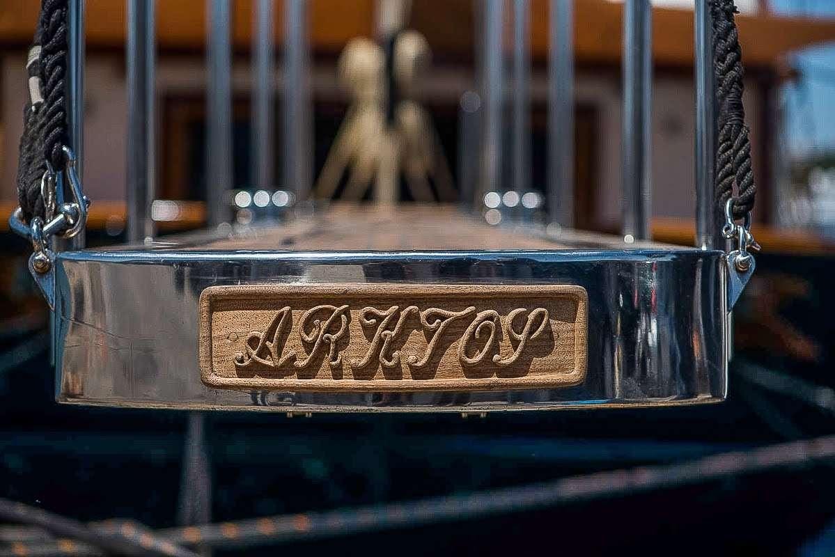 a sign on a gate aboard ARKTOS Yacht for Charter