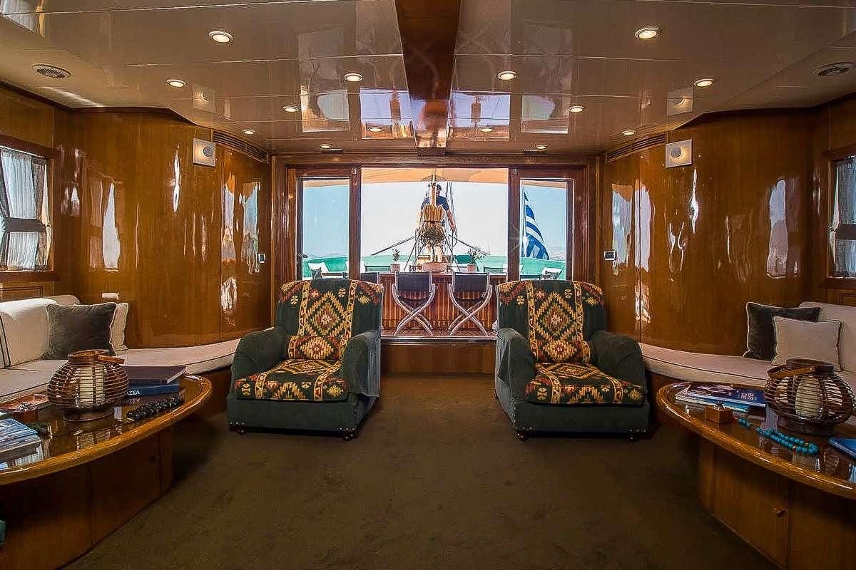 a living room with a large window aboard ARKTOS Yacht for Charter