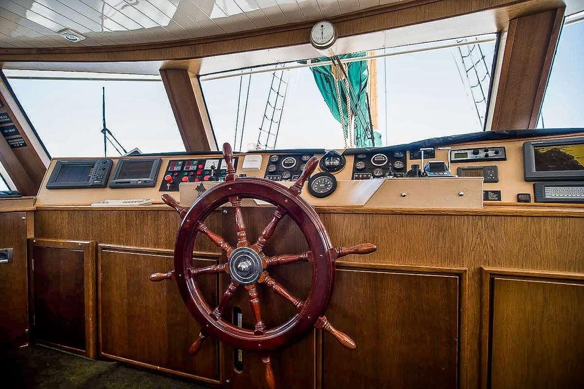 a wooden object with a large wheel aboard ARKTOS Yacht for Charter
