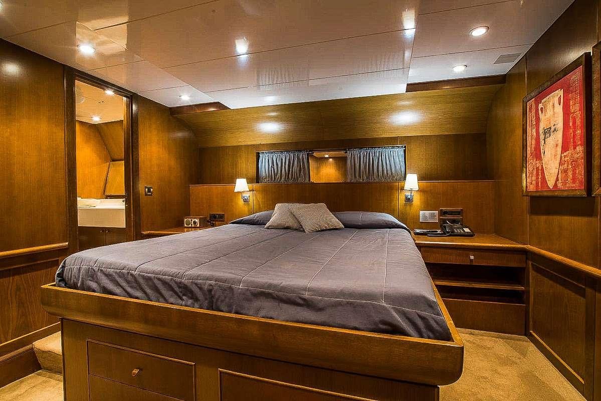 a bed in a room aboard ARKTOS Yacht for Charter