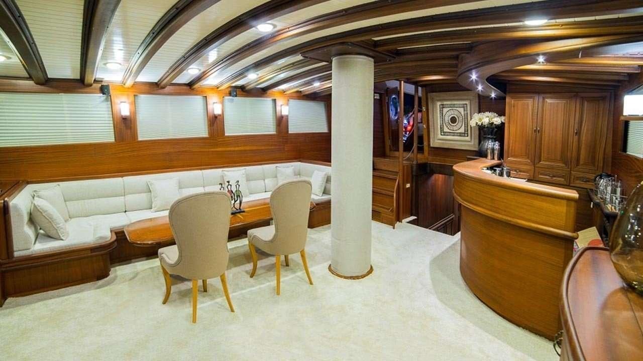 a room with a bed and desk aboard WICKED FELINA Yacht for Charter