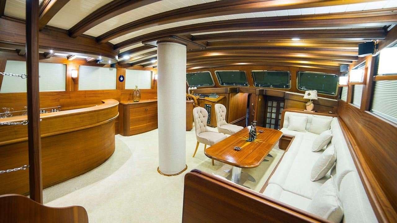 a room with a table and chairs aboard WICKED FELINA Yacht for Charter