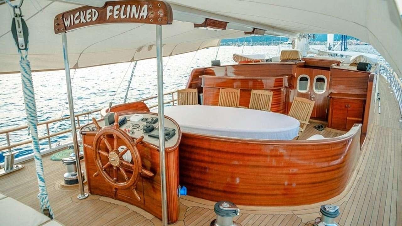 a boat with a wooden boat aboard WICKED FELINA Yacht for Charter