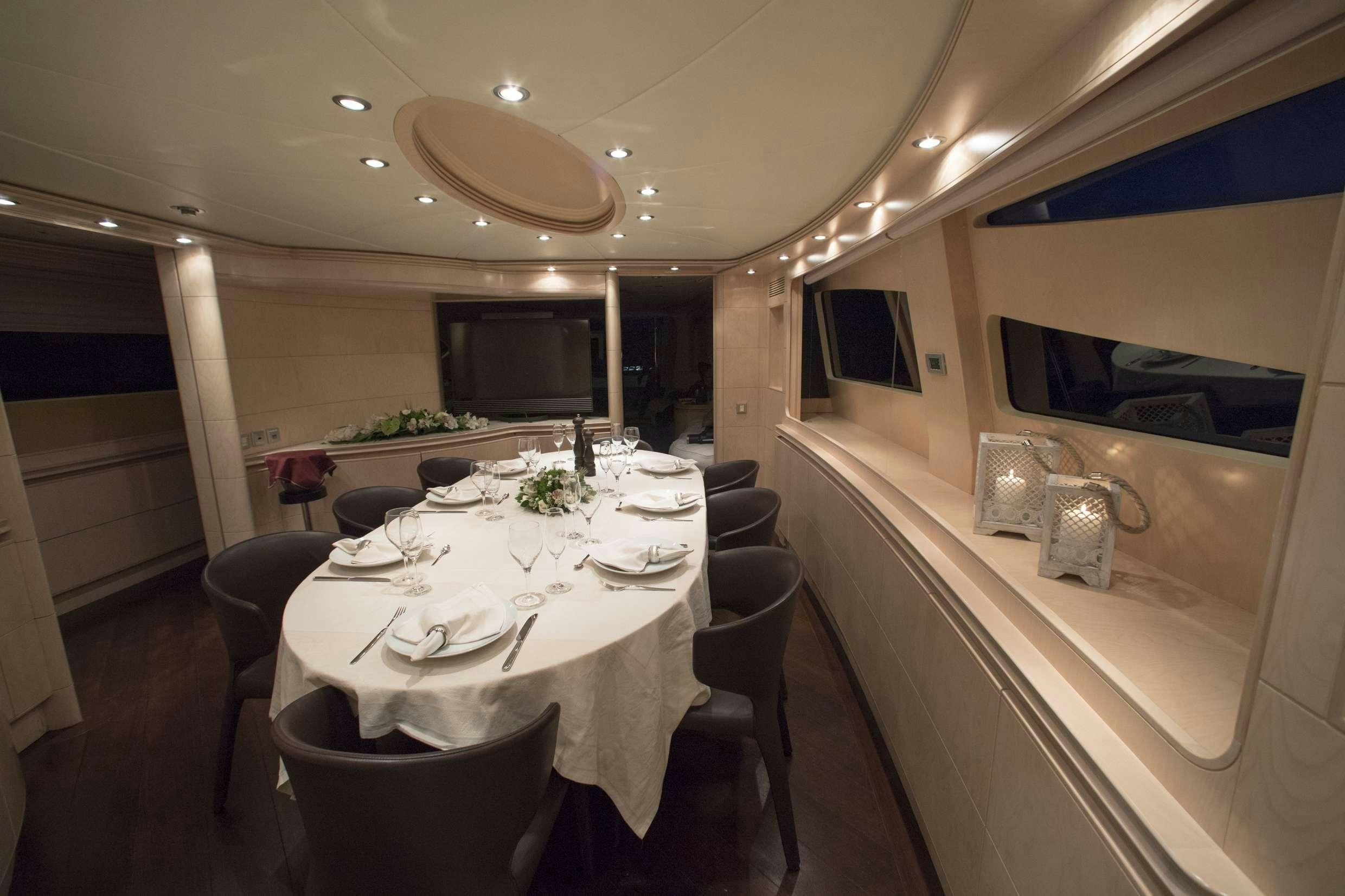 a large white table with chairs around it aboard PRINCESS L Yacht for Charter