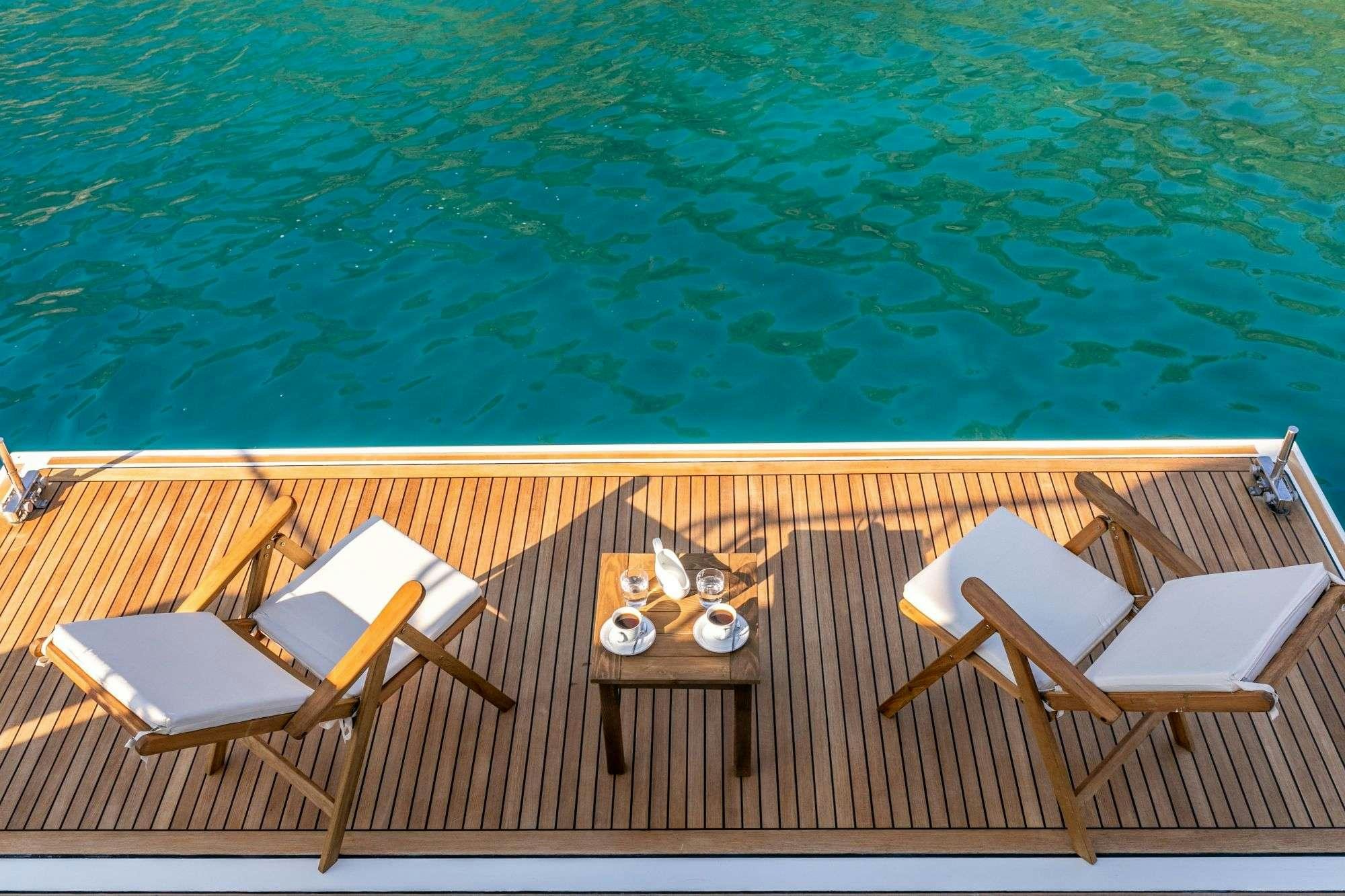 a table and chairs on a deck aboard FUNDA D Yacht for Charter