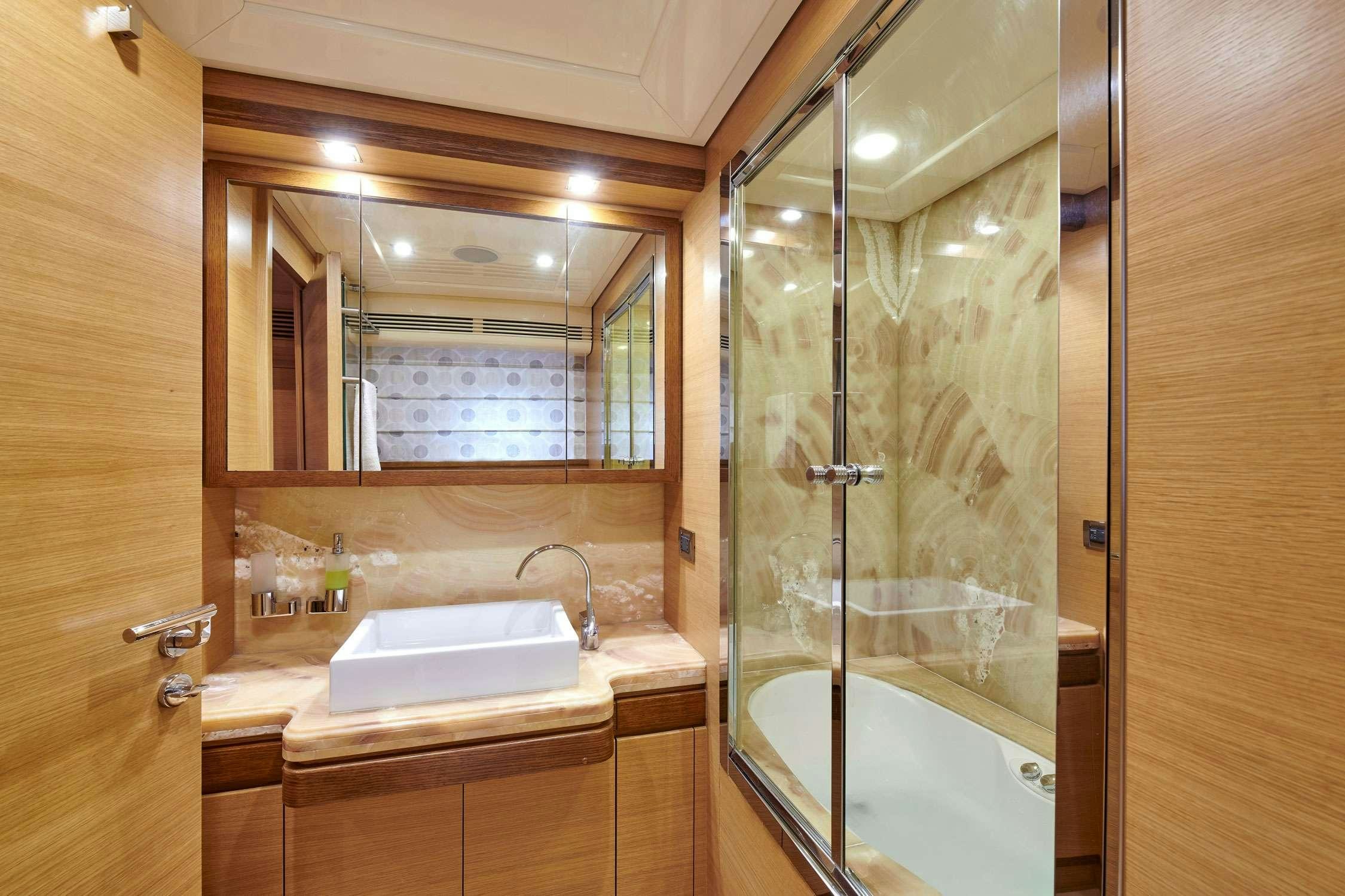 a bathroom with a glass shower aboard SEVEN S Yacht for Charter