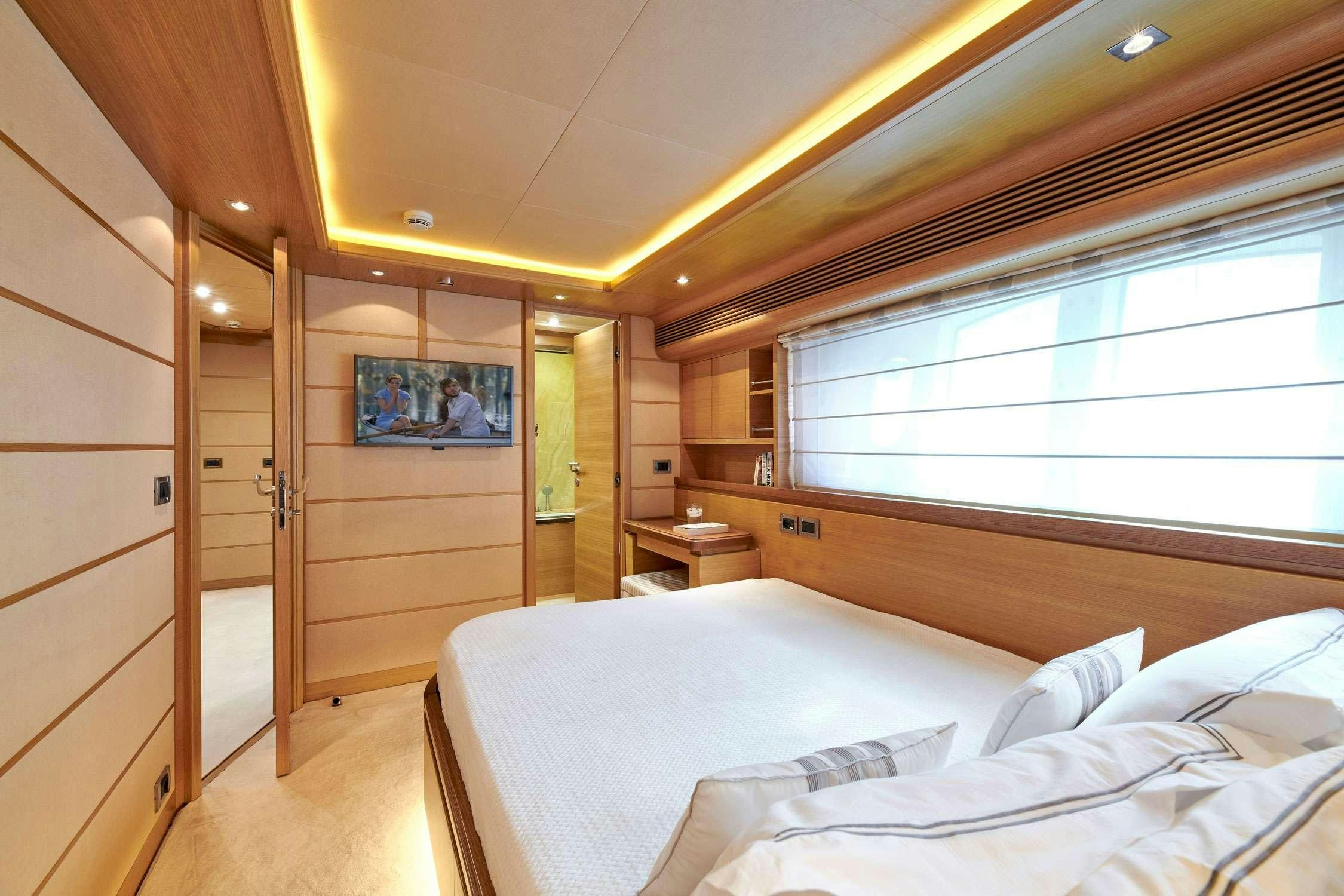 a room with a bed and a mirror aboard SEVEN S Yacht for Charter