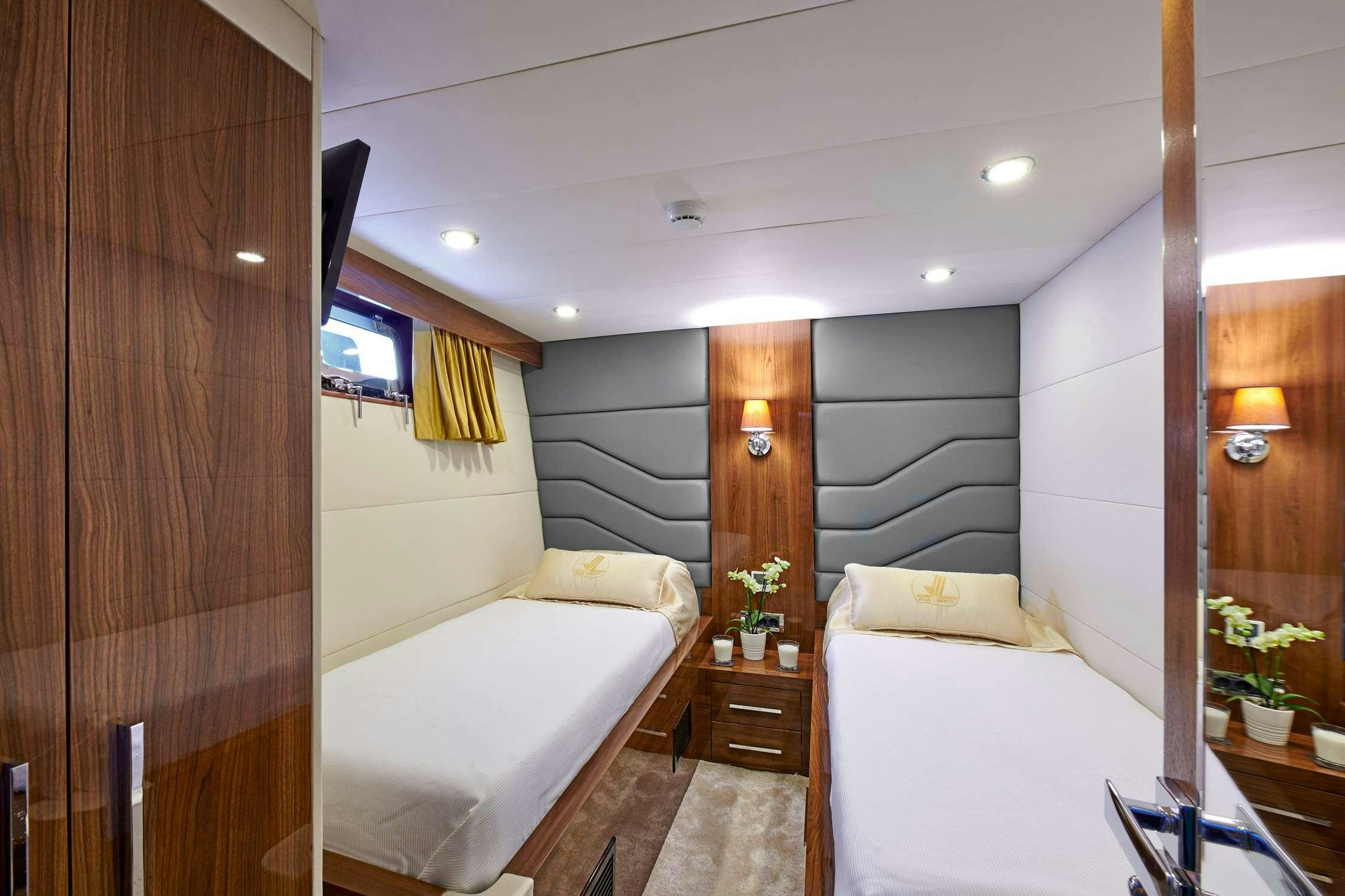 a room with a bed and a mirror aboard WIDE LIBERTY Yacht for Charter