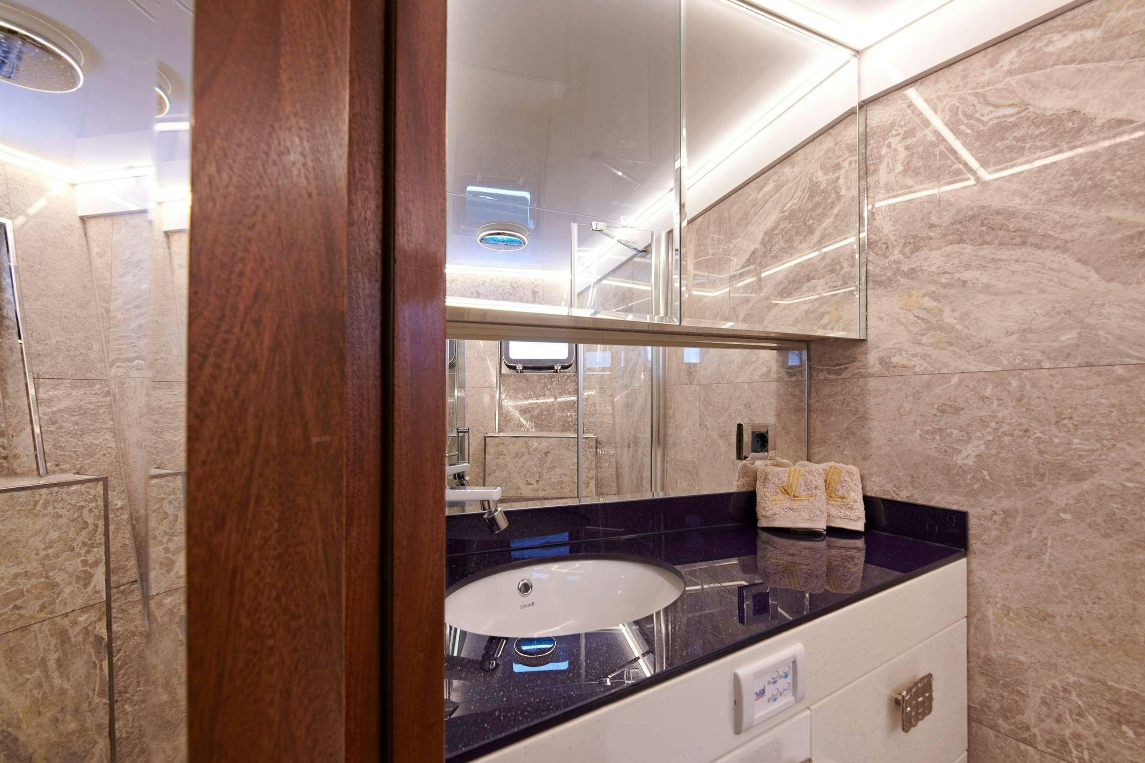 a bathroom with a sink and a mirror aboard WIDE LIBERTY Yacht for Charter
