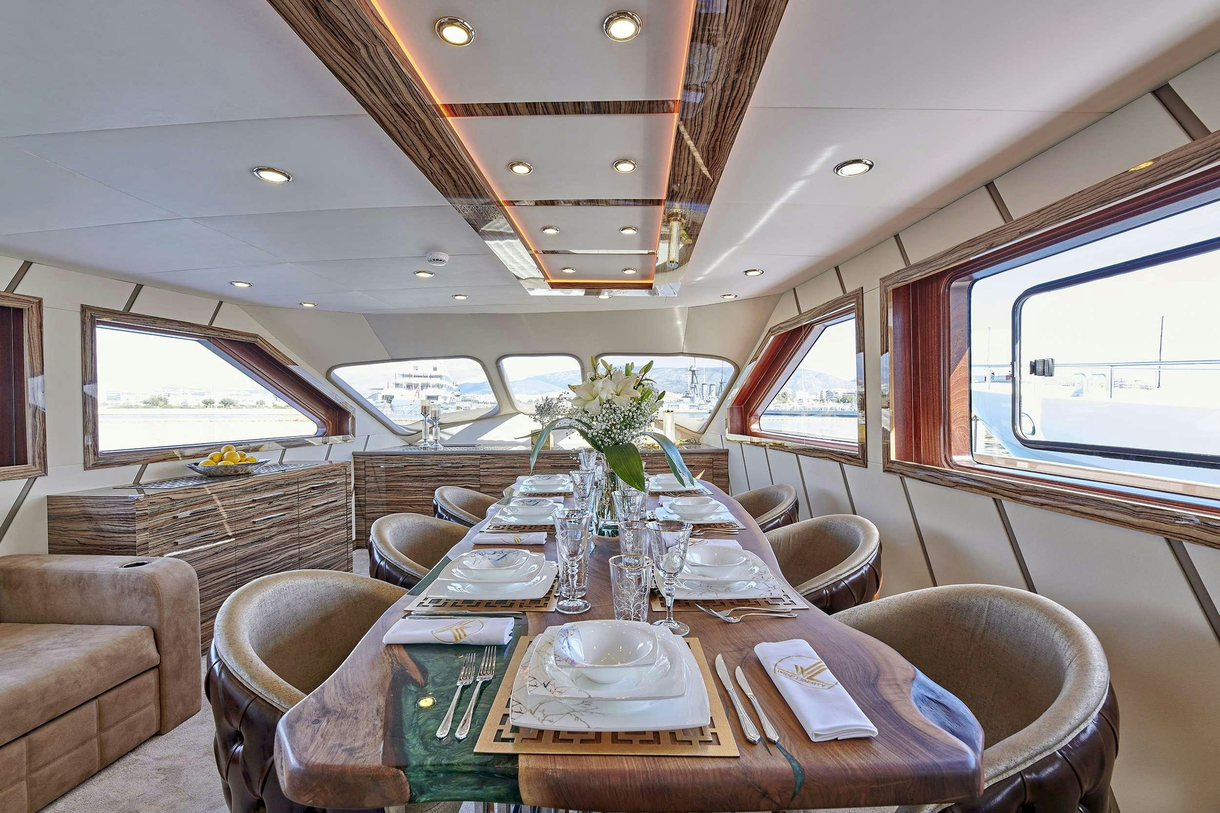 a dining table in a train aboard WIDE LIBERTY Yacht for Charter